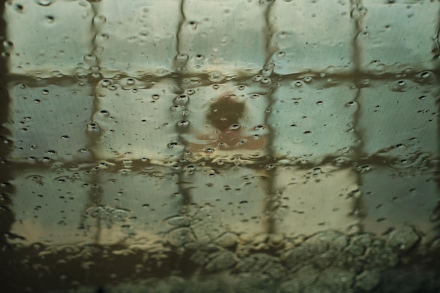 Photo reflection of fence in puddle during rainy season