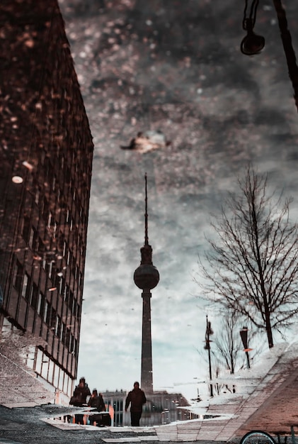 Reflection of fernsehturm on puddle