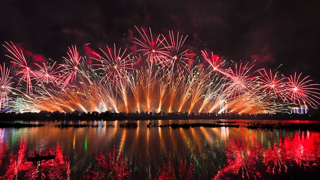 Photo reflection of firework display on river at night