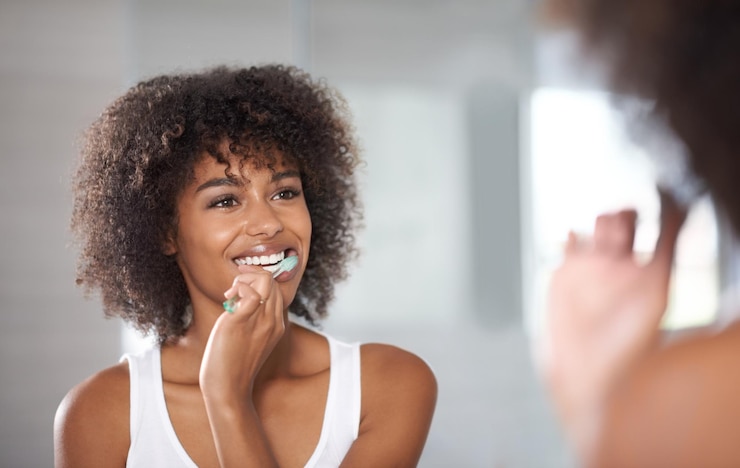 Photo reflection health and black woman brushing teeth cosmetics and oral health at home female person model and girl cleaning her mouth mirror and dental hygiene with fresh breath wellness and care