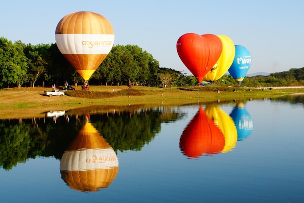 Reflection of hot air balloon in lake