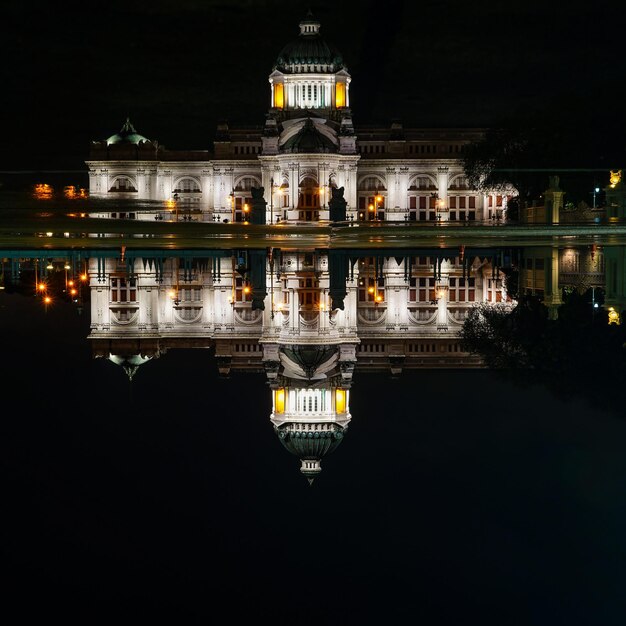 Reflection of illuminated building in lake at night