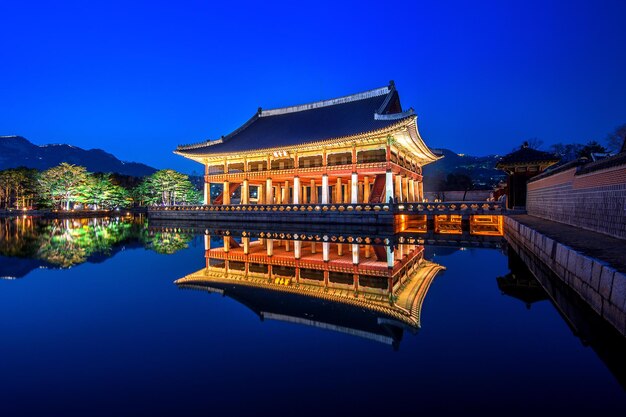 Reflection of illuminated building in water at night