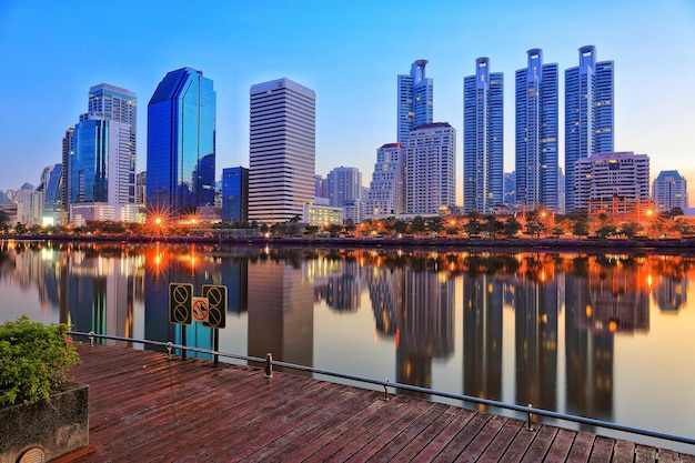 Reflection of illuminated buildings in river against sky