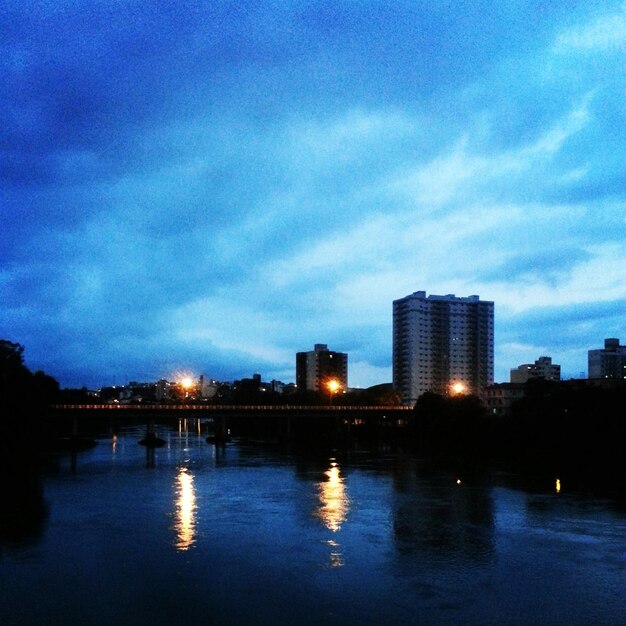 Reflection of illuminated buildings in water at dusk