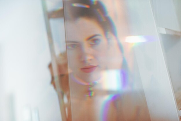 Photo reflection of mid adult woman seen on glass