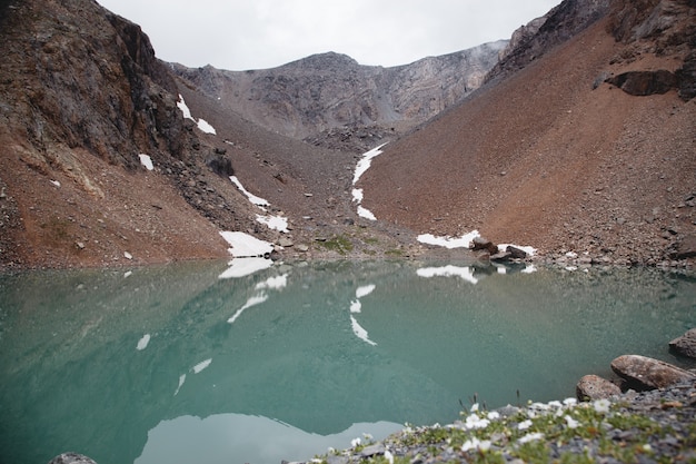 Riflessione di un paesaggio di montagna nelle acque turchesi di un lago. lago sugli altipiani di altai