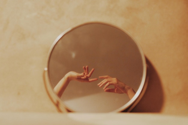 Photo reflection oh hands on mirror