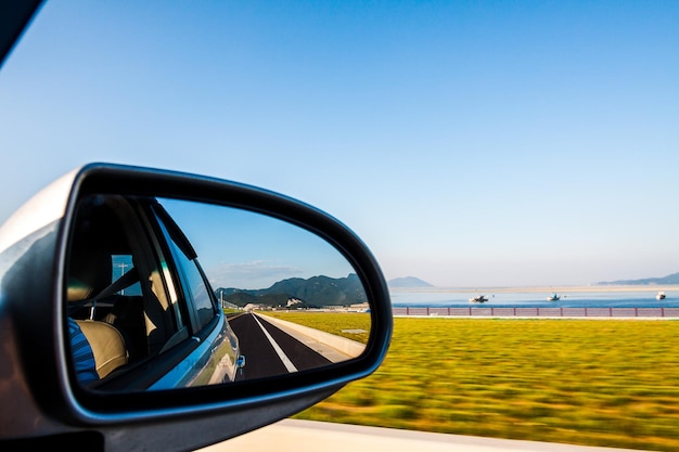 reflection of road on car side-view mirror