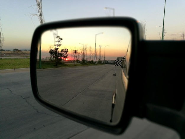 Photo reflection of road on side-view mirror