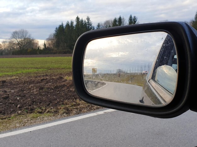 Photo reflection of road on side-view mirror