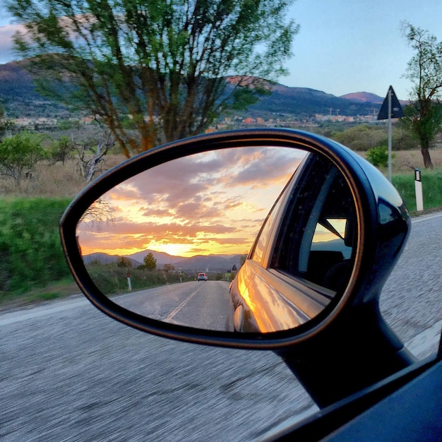 Photo reflection of road on side-view mirror