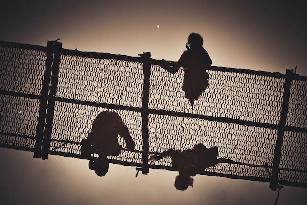 Reflection silhouettes of people in the river