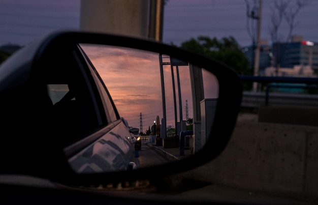 Photo reflection of sky on side-view mirror