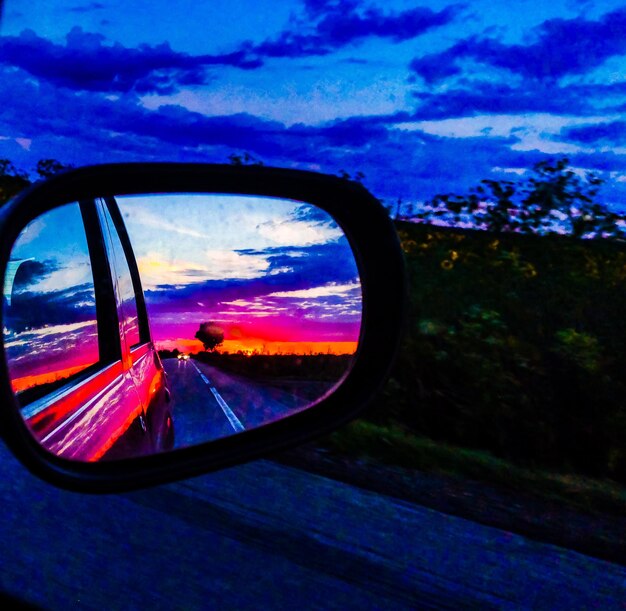 Reflection of sky on side-view mirror