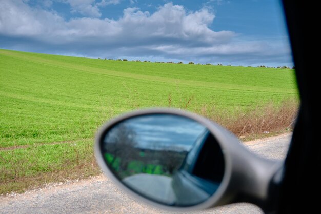 Photo reflection of sky on side-view mirror