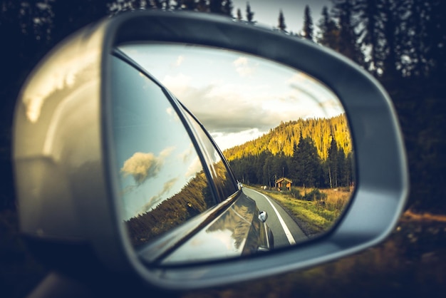 Photo reflection of sky on side-view mirror