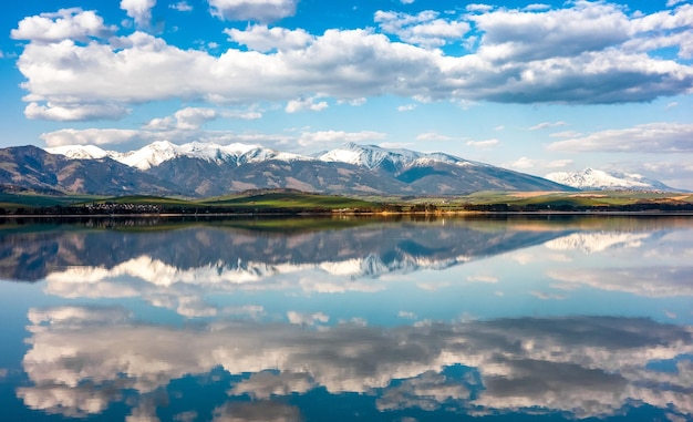 Reflection of snowy peaks in calm lake