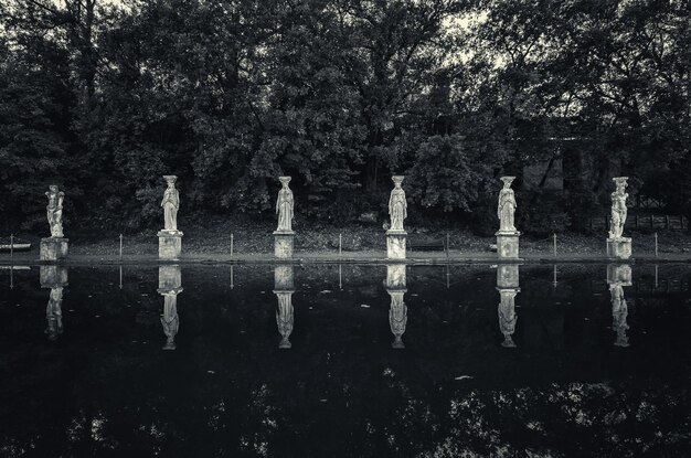 Photo reflection of statues in lake