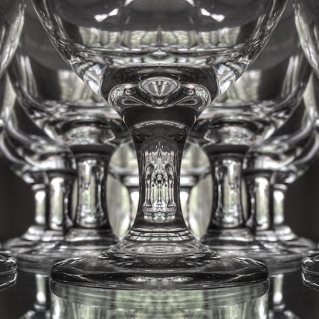 Photo reflection on stem of wineglasses