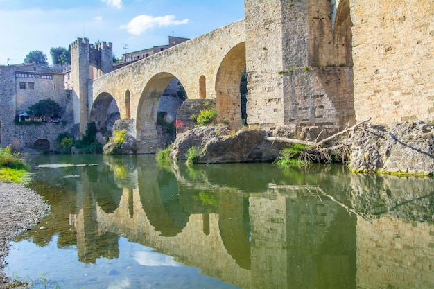 Reflection stone bridge over river