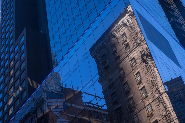 Photo reflection of stone building in a modern sky-scraper new york city