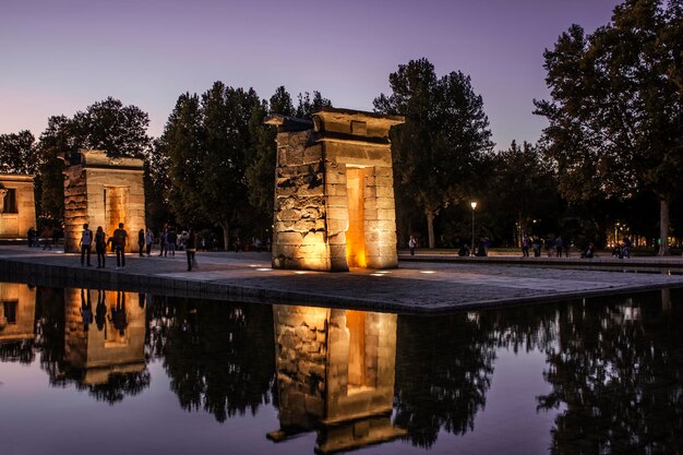 Reflection of temple of debod in water at dusk