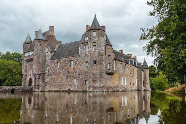 Reflections of the medieval Chateau Trecesson in the lake, CampÃÂÃÂ©nÃÂÃÂ©ac commune in the Morbihan department, near the Broceliande forest.