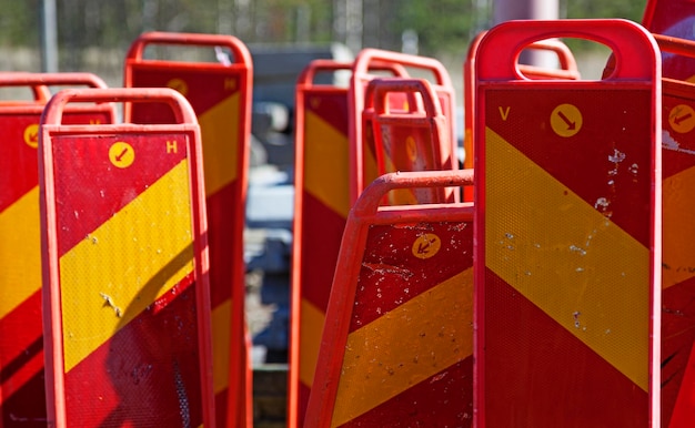 Reflective signs used in road construction stand next to each other