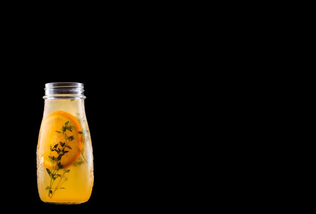 Refreshing citrus fruits lemonade isolated on a black.