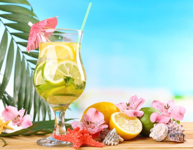 Refreshing cocktail on beach table