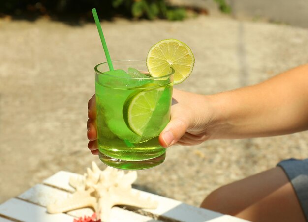 Refreshing cocktail in hand