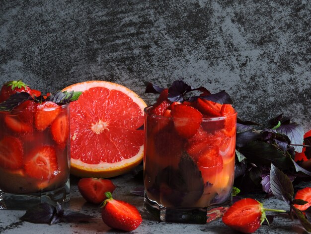 Refreshing detox drink for weight loss with strawberries, grapefruit and blue basil.