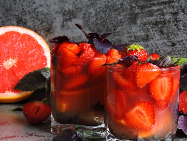 Refreshing detox drink for weight loss with strawberries, grapefruit and blue basil.