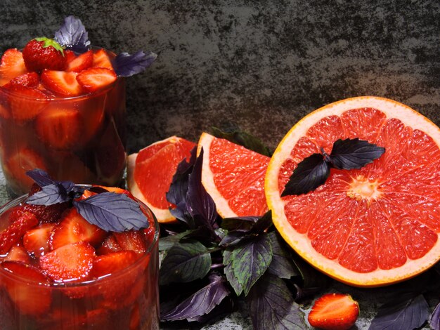 Refreshing detox drink for weight loss with strawberries, grapefruit and blue basil.