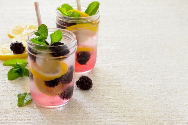 Refreshing drink with blackberries, lemon and mint