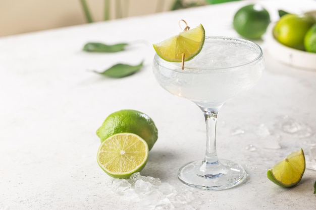 Refreshing Homemade Classic Alcoholic Margarita Cocktail with Lime and Salt on light background