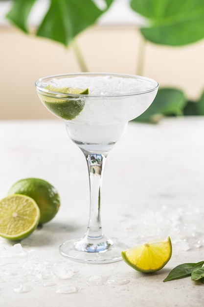 Refreshing Homemade Classic Alcoholic Margarita Cocktail with Lime and Salt on light background