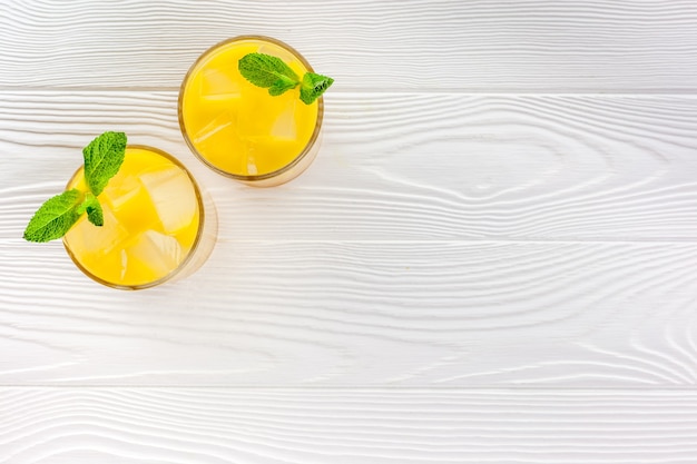 Refreshing orange juice with ice cubes