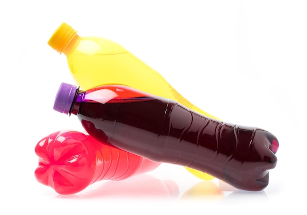 Refreshing pineapple ,raspberry, and grape drink in plastic bottle isolated on white background