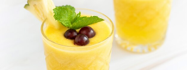 Refreshing pineapple summer drink on marble table