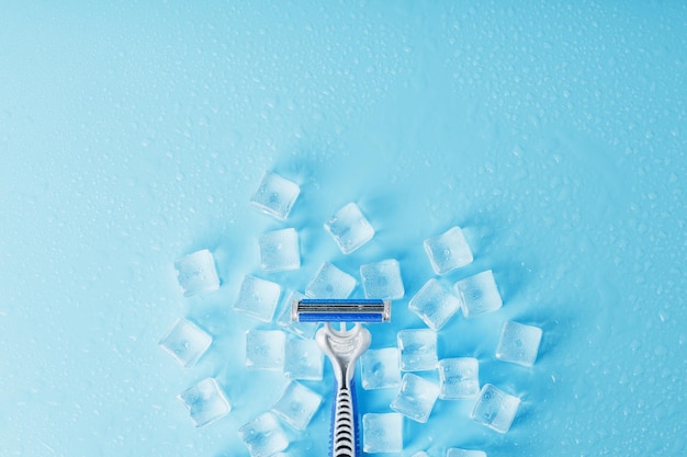 Refreshing shaving machines for the face against the background of frosty ice cubes