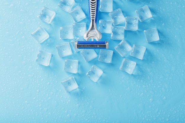 Refreshing shaving machines for the face against the background\
of frosty ice cubes