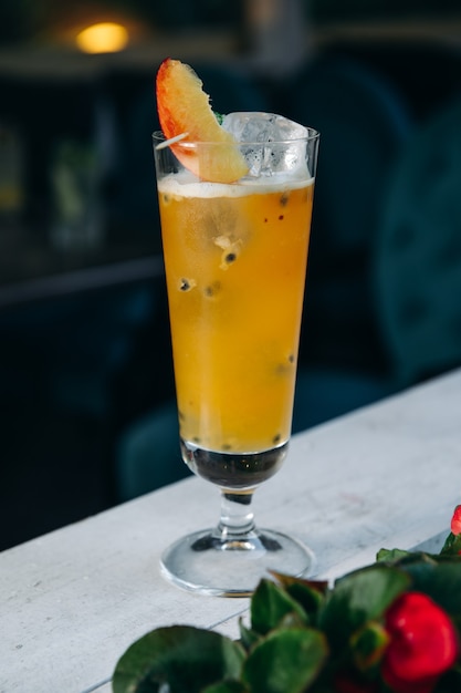 Refreshing summer cocktail with peach and passion fruit