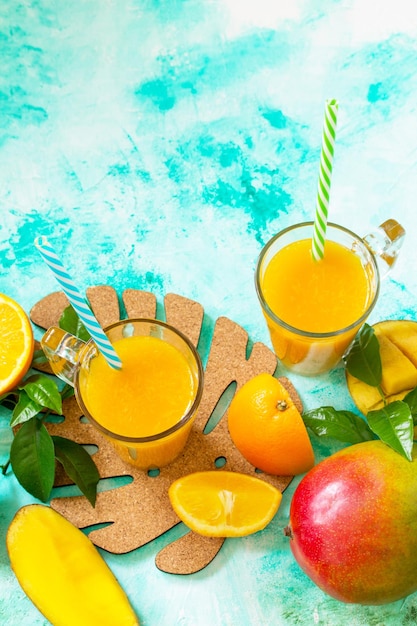 Refreshing summer mango and citrus freshly squeezed juice concept of vegetarian