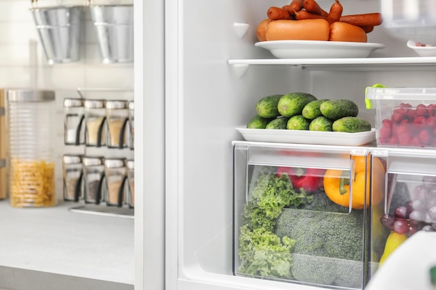 Refrigerator with different products in kitchen