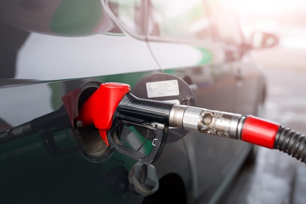 Refueling a car with gasoline or diesel fuel at a gas station.