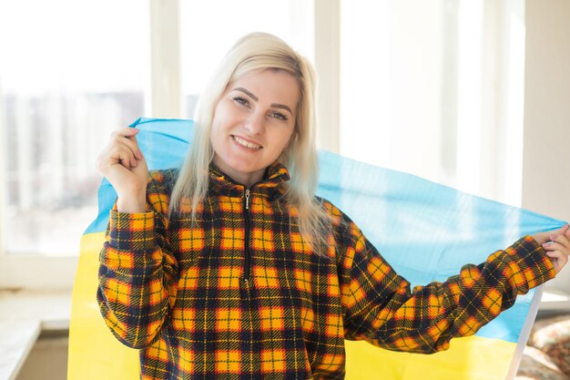 Refugee woman with flag of ukraine