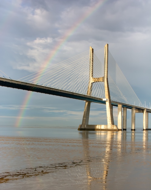 Regenboog op de Vasco de Gama-brug, Lissabon, Portugal