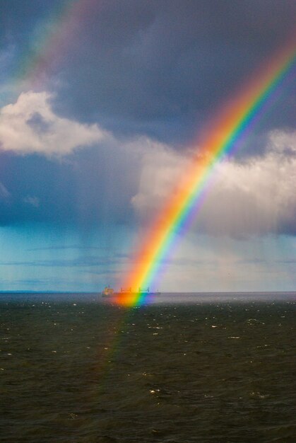 Foto regenboog over de zee tegen de lucht